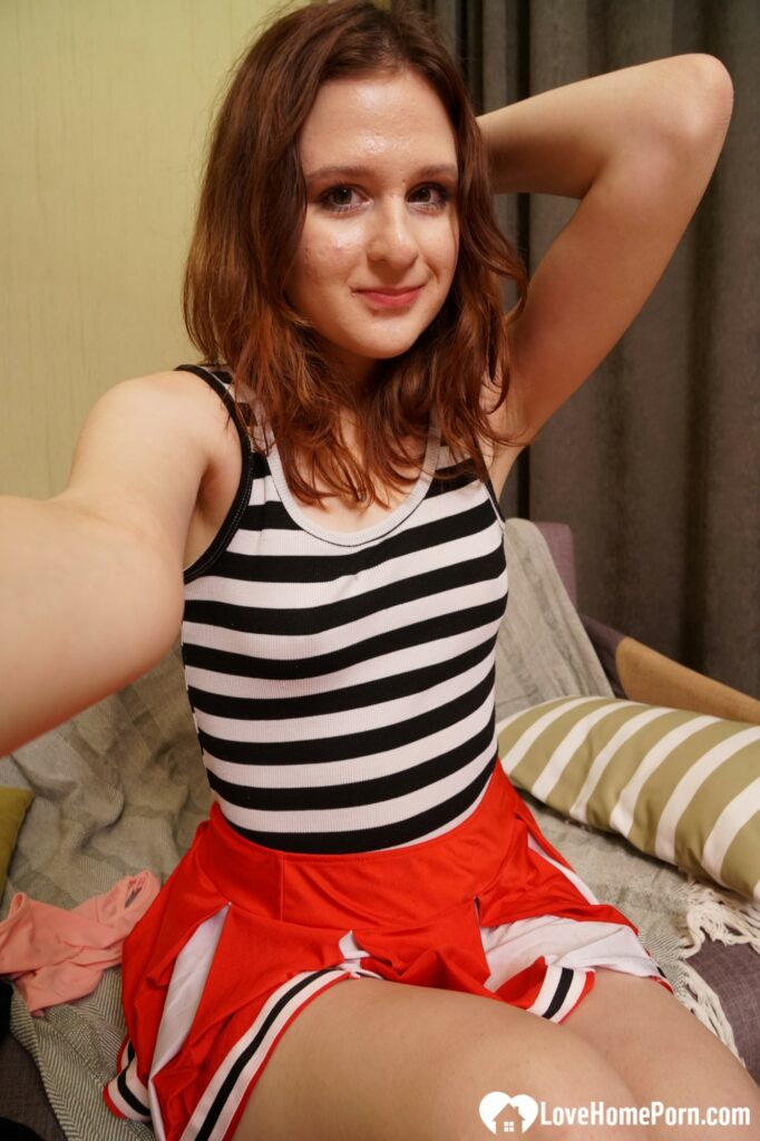 Redhead cutie shows off outfits and gets nude